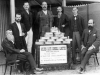 group-of-men-gathered-around-a-table-full-of-gold-ingots-from-golden-gate-mine-croydon-1904
